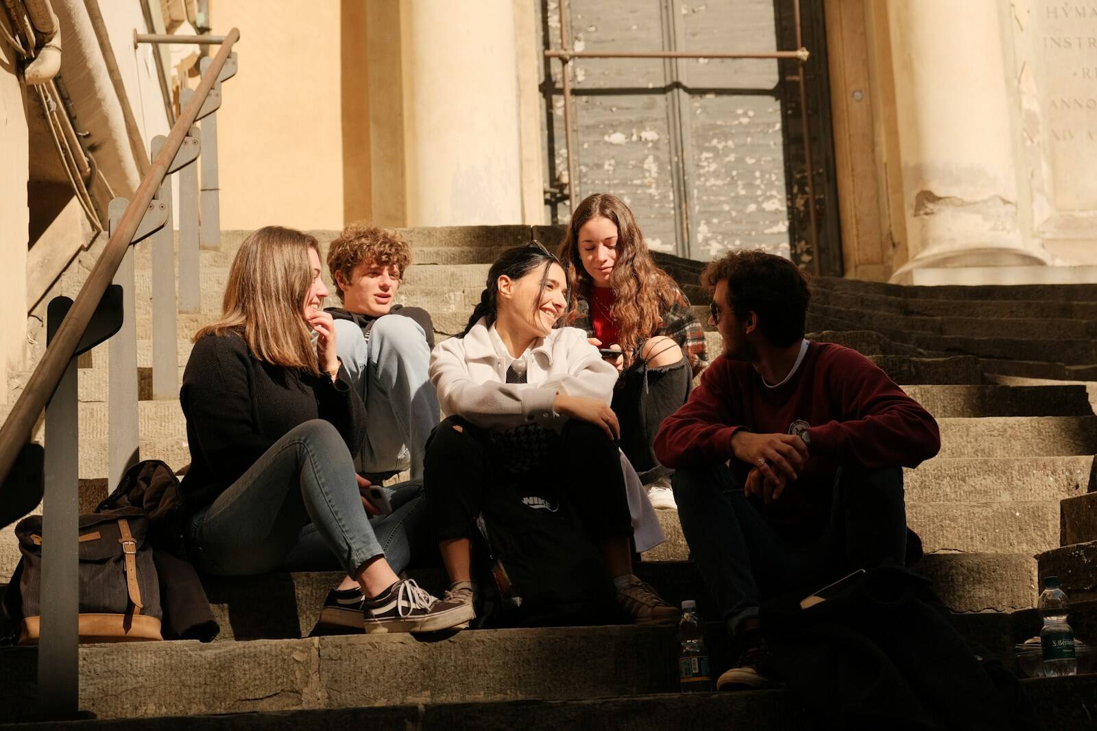 a group of people sitting on the steps of a building